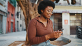 Smiling African woman in casuals chatting with friends on phone. - PhotoDune Item for Sale