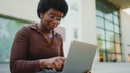 Female entrepreneur working on laptop outdoors. African American - PhotoDune Item for Sale
