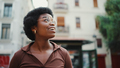 Portrait of Afro American dark haired girl looking cheerful walk around city. Happy expression - PhotoDune Item for Sale