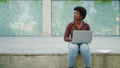 African American curly haired woman looking pensive working on l - PhotoDune Item for Sale