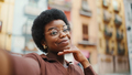 Beautiful African American curly girl looking cute taking selfie - PhotoDune Item for Sale