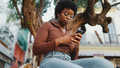 African curly girl in glasses typing text message on smartphone - PhotoDune Item for Sale