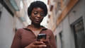 Young Afro girl wearing glasses texting on a smartphone. Female - PhotoDune Item for Sale