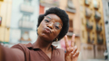 African American dark haired girl wearing glasses sending kiss t - PhotoDune Item for Sale