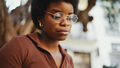 Close up Afro girl wearing glasses looking concentrated during b - PhotoDune Item for Sale