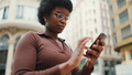 Attractive black African girl wearing eyeglasses on the street using smartphone looking concentrated - PhotoDune Item for Sale