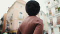 Back view of dark haired African woman standing on a street. Att - PhotoDune Item for Sale