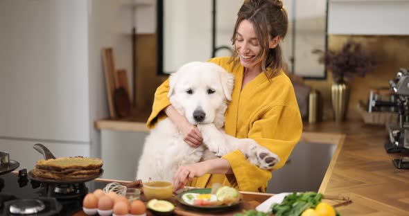 Woman with Dog on the Kitchen in the Morning