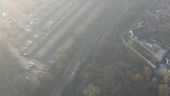 Train on Railroad Track at Foggy Weather. Locomotive Passing in the Misty Morning. Aerial Footage