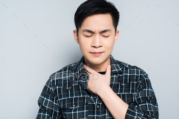 le suffering from sore throat isolated on grey