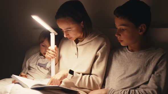 Mom Reading Book to Children