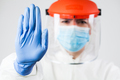 Lab scientist EMS ICU doctor wearing N95 biohazard PPE protective suit raised hand gesturing STOP - PhotoDune Item for Sale
