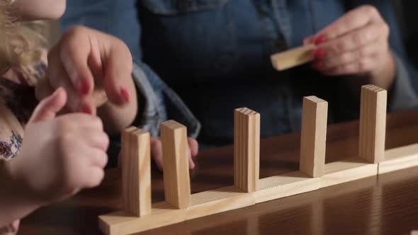 Educational Board games for family.  mother and daughter play with wooden blocks