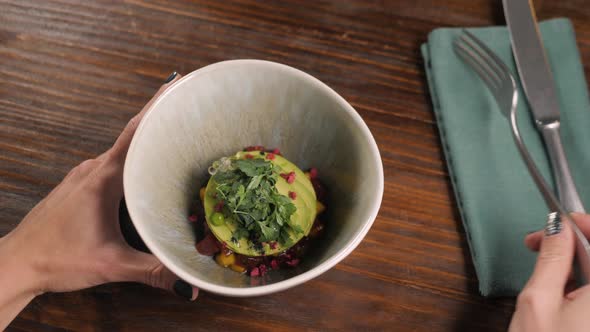 Food New Nordic Cuisine and People Concept Woman Eating Breaded Fish Fillet with Tartar Poke Salad