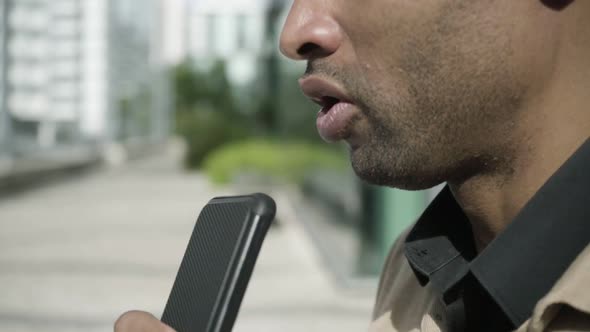 Lower Face of Young Black Man Talking on Cell Phone on Speaker