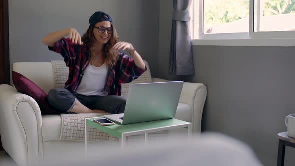 Cheerful Young Adult Girl Making a Video Call with a Laptop, Gesturing,