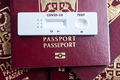 Rapid serology COVID-19 test cassette on red biometric passport - PhotoDune Item for Sale