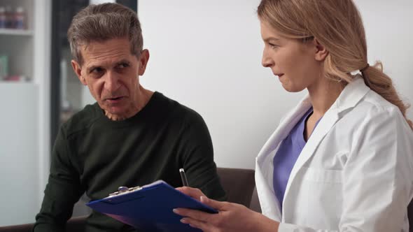 Senior man makes talking with doctor in waiting room. Shot with RED helium camera in 8K.