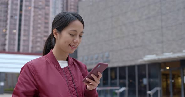 Woman use of mobile phone in city