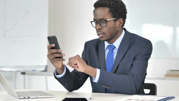 African Businessman Using Smartphone Text Messaging