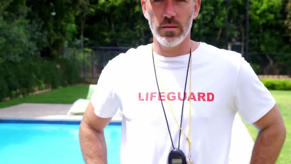 Lifeguard standing at pool side