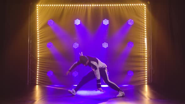 Young Active Man Dressed in Sportswear, Performs in Break Dance Style. Training in Dance Studio