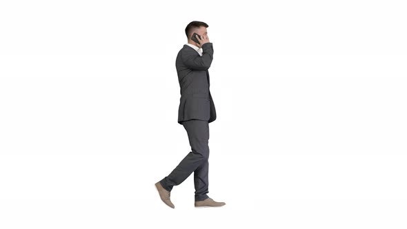 Businessman Walking and Talking on Mobile Phone on White Background