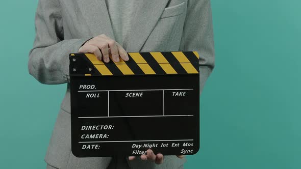 Movie slate or clapperboard hitting. Business woman holding empty film slate and clapping it.