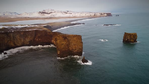 Aerial view of Dyrholaey peninsula with the black arch of lava.