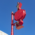 An advertising sign with arrows and lights on a post against blue sky. - PhotoDune Item for Sale