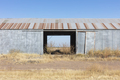 Abandoned rusting metal farm building with large open doors. - PhotoDune Item for Sale