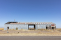 Abandoned rusting metal farm building with large open doors. - PhotoDune Item for Sale