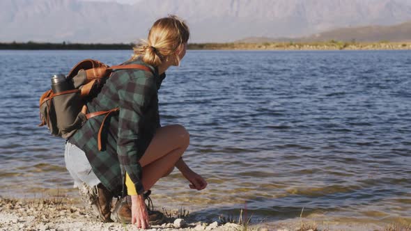 Caucasian woman by a lake in nature.