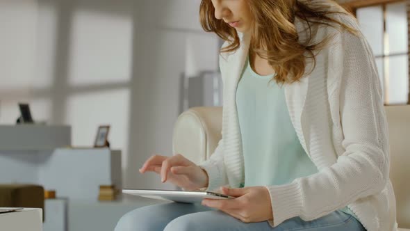 Busy Female Student Works Actively on Tablet PC, Typing Quickly