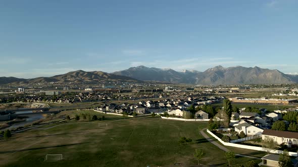 Suburban community with office buildings in the foothills below the mountains and a river in the val