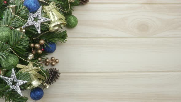 Christmas fir branch with decor on wooden background