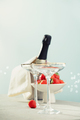 Bottle of champagne, two glasses and strawberries on sea and sky background. - PhotoDune Item for Sale