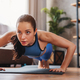 Home training. Happy Latin girl doing push ups on yoga mat indoors Stock  Photo by Prostock-studio