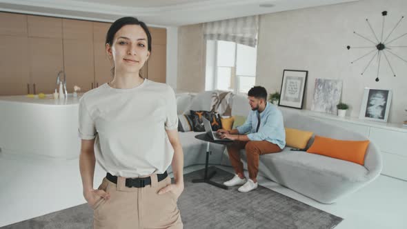 Portrait Of Young Hispanic Woman In Modern Design Living Room