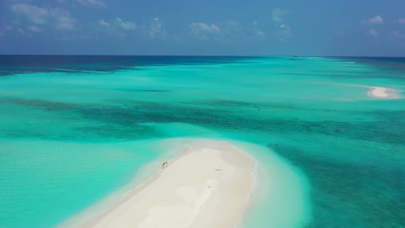 Aerial above nature of tranquil seashore beach vacation by blue green ocean with white sand backgrou