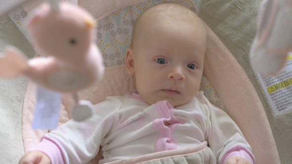 Two Months Old Baby Girl Under the Baby Mobile