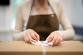 Woman hands wrapping a present in a box in the shop - PhotoDune Item for Sale