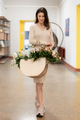 Woman walking to work with a bag with fresh flowers - PhotoDune Item for Sale