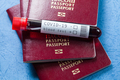 Several passports and test tube with blood sample - PhotoDune Item for Sale