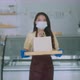 Attractive asian female cafe worker wears face mask and gloves giving takeaway food bag - VideoHive Item for Sale