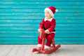 Happy child dressed Santa Claus hat against blue background - PhotoDune Item for Sale