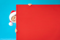 Happy child holding red Christmas banner blank against blue background - PhotoDune Item for Sale