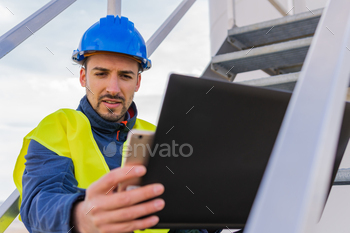  Worker in the industrial sector checking the operation of power generators.