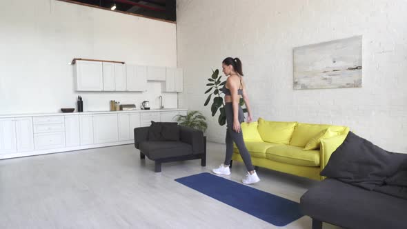 Beautiful Young Woman Doing Fitness at Home