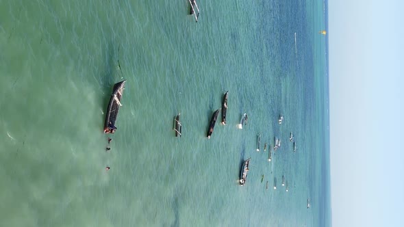 Vertical Video Boats in the Ocean Near the Coast of Zanzibar Tanzania Aerial View